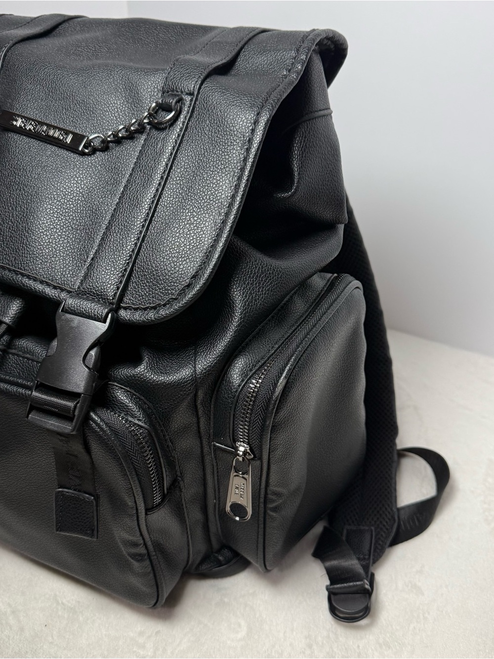 Steve Madden Black Pebbled Faux Leather Drawstring Backpack with Chain Trim - Picture 3 of 8